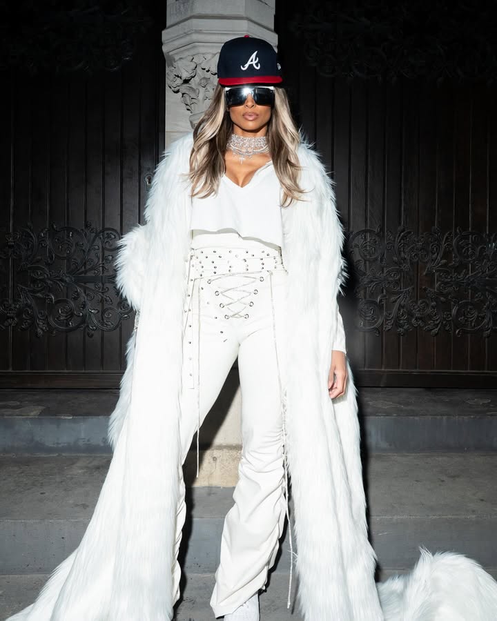 May be an image of one or more people, makeup, fur coat, hat and text