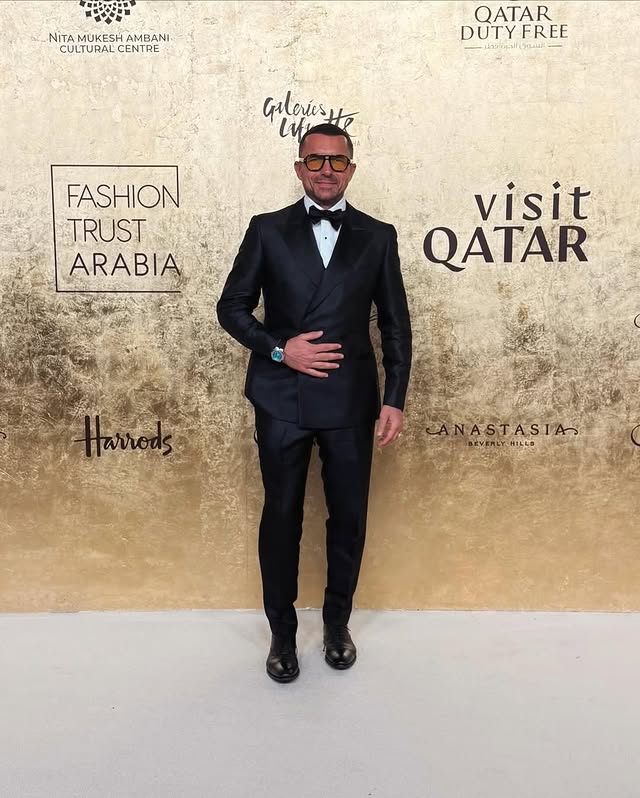 May be an image of suit, dinner jacket, bowtie and text