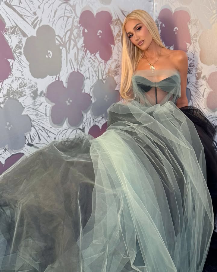 May be an image of one or more people, makeup, gown, dress and text