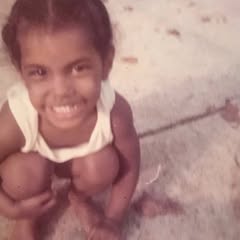 May be an image of child, smiling and text