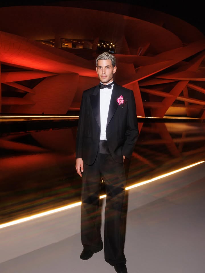 May be an image of suit, dinner jacket, bowtie and text