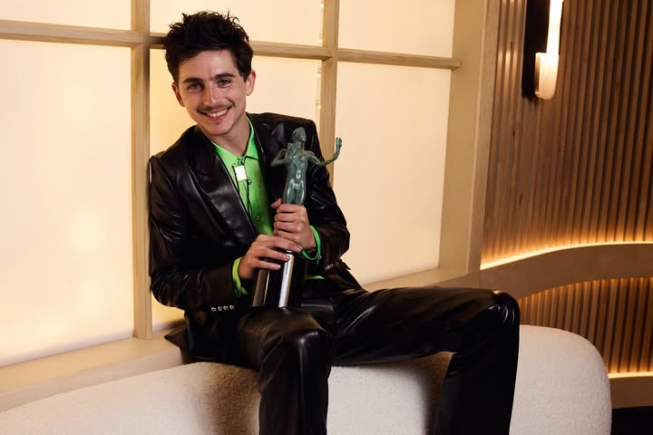 May be an image of one or more people and text