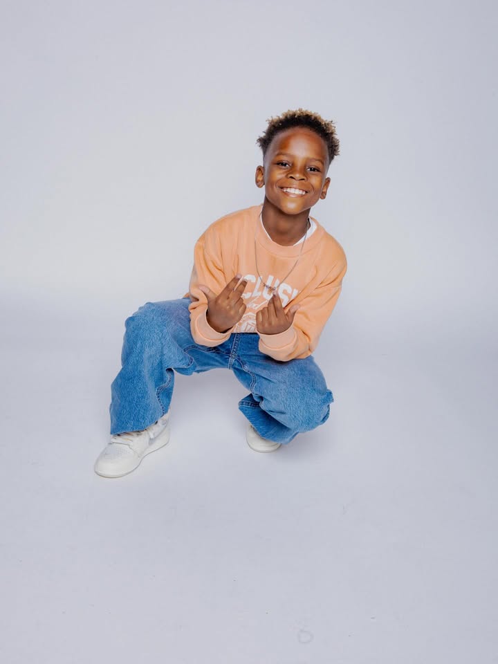 May be an image of child, smiling and text