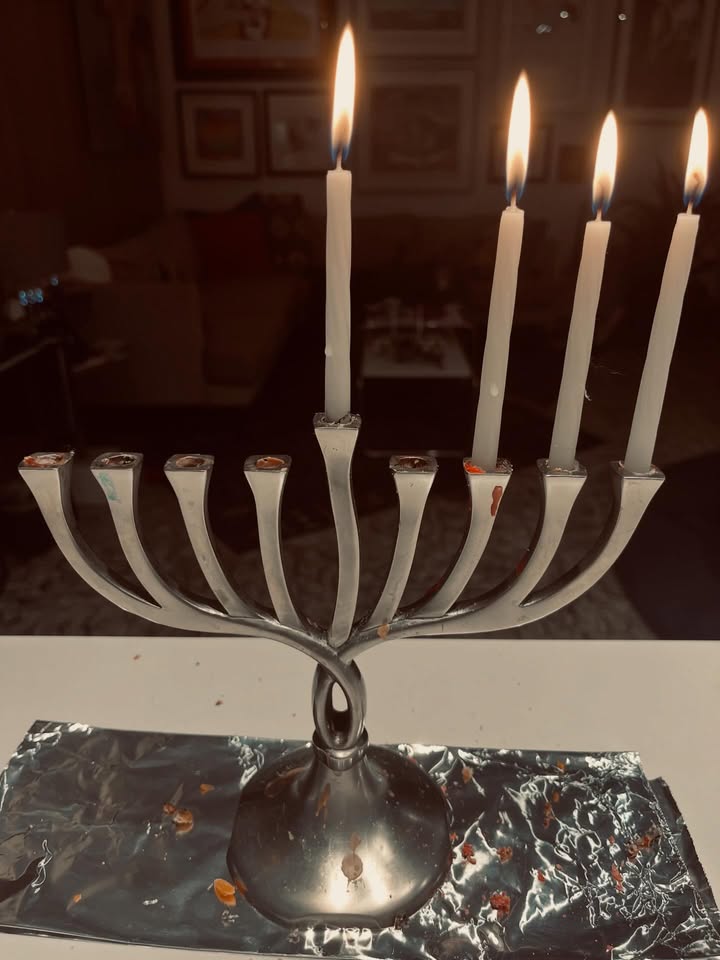 May be an image of candle holder, candle and text