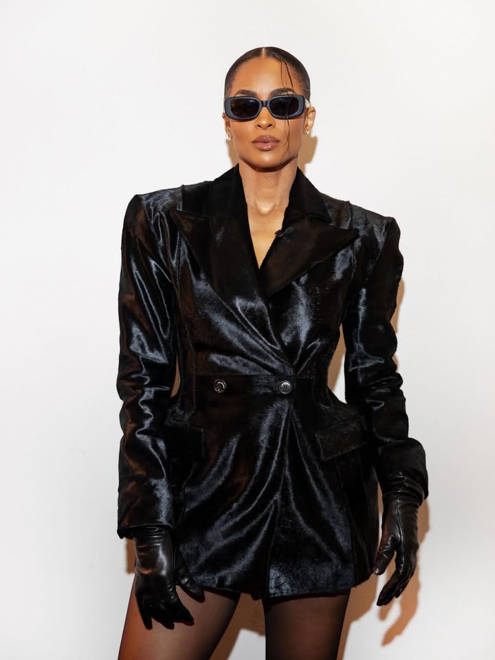 May be an image of leather, eyewear, blazer, coat and text