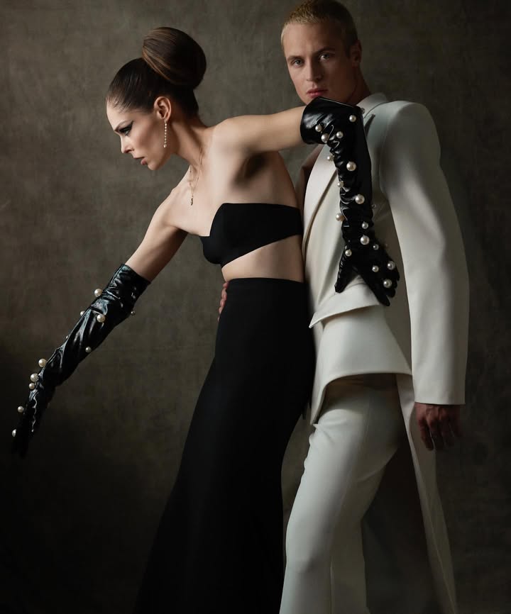 May be an image of one or more people, makeup, suit, dress, gown, dinner jacket and text