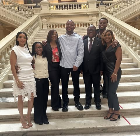 May be an image of one or more people and text