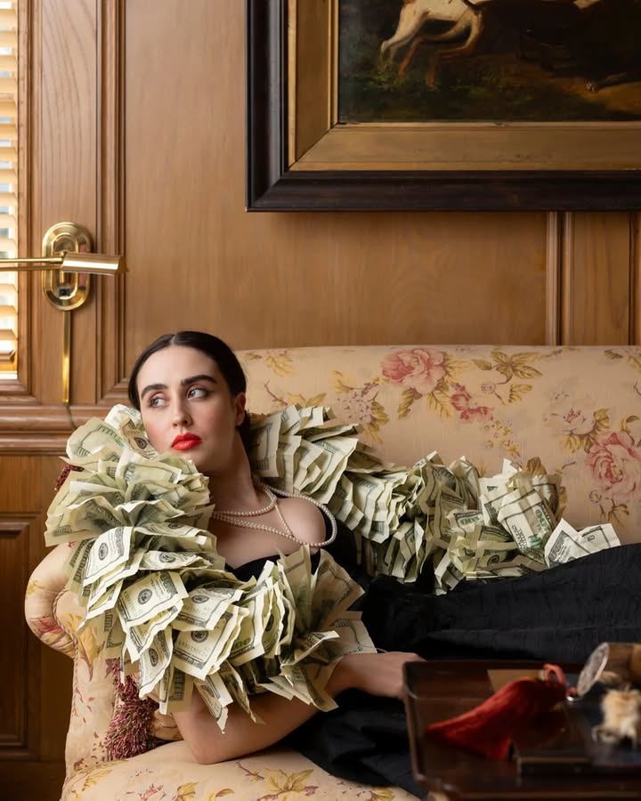 May be an image of one or more people, makeup, headdress, chaise lounge and text