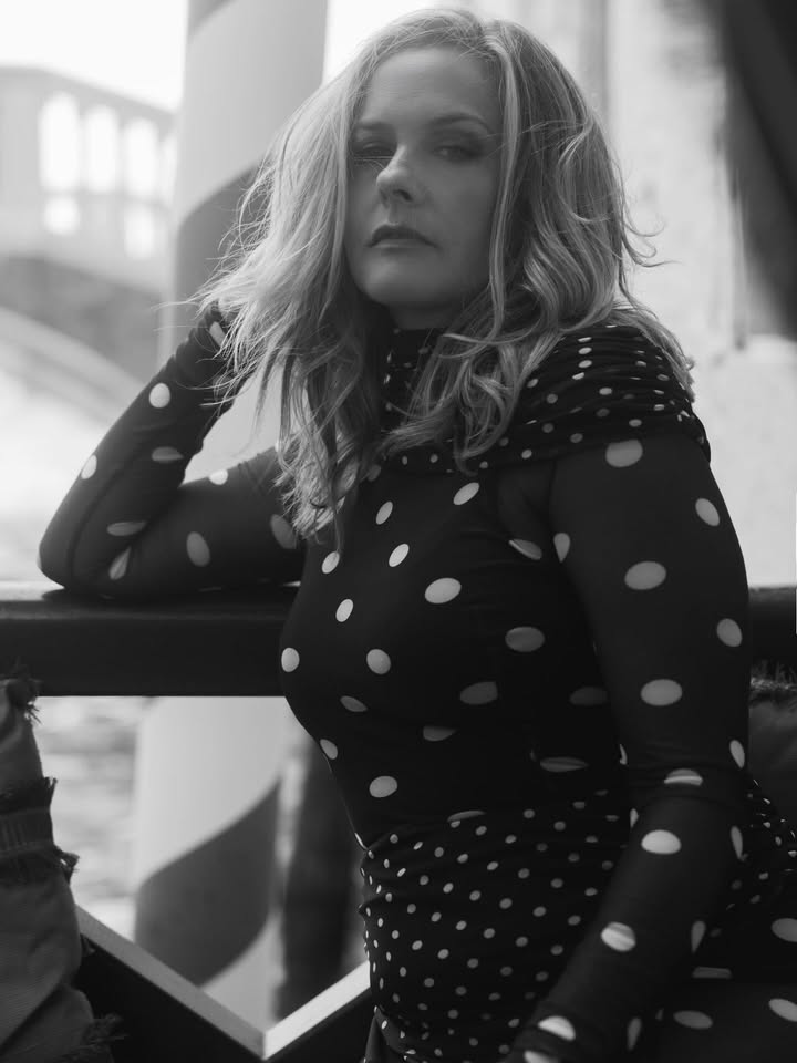 May be a black-and-white image of one or more people, turtleneck, fishnet stockings, bridge and text